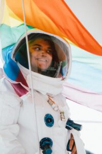 person in a space suit holding a flag
