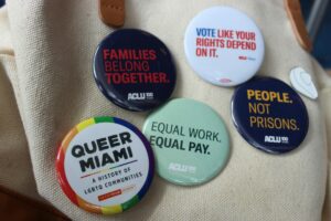 pin buttons with slogans on a bag